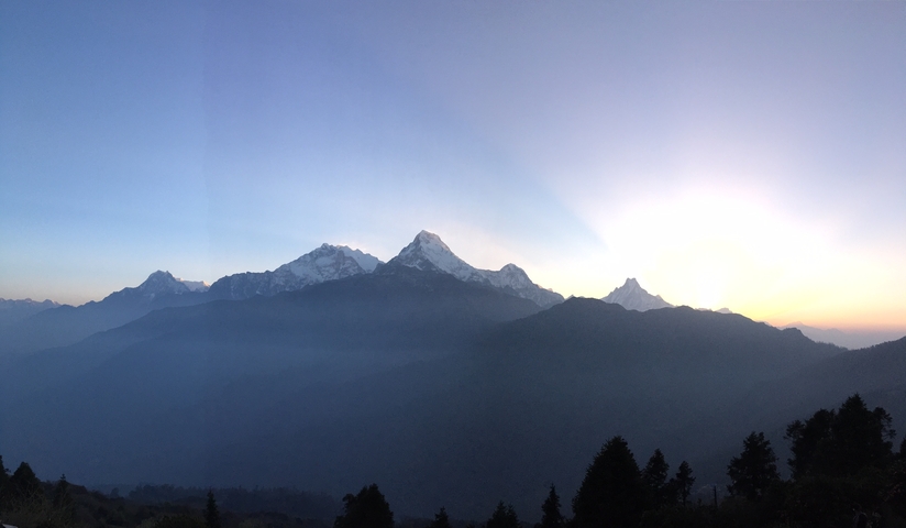 Snowy mountain peaks during sunrise.