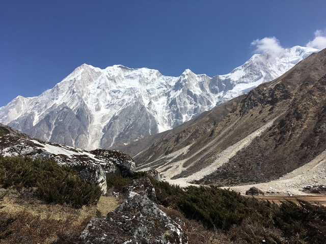 Majestic snow-capped mountains under a clear blue sky.