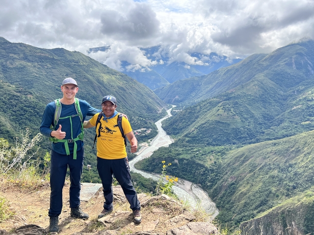 Two people overlooking a river valley in Peru.
