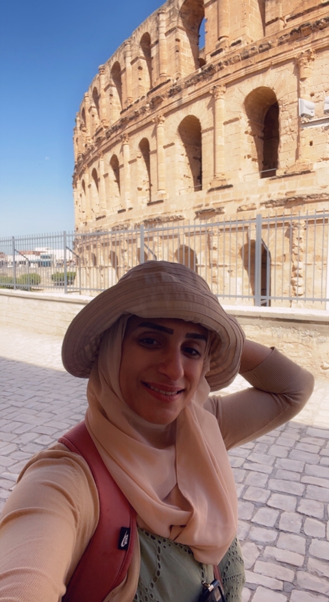      Selfie with a background of historical ruins.
  