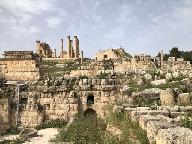 Ancient ruins with columns and stone structures.