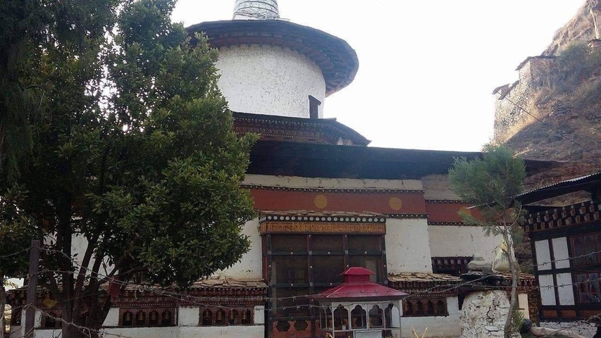       White round structure with traditional Bhutanese design.
  