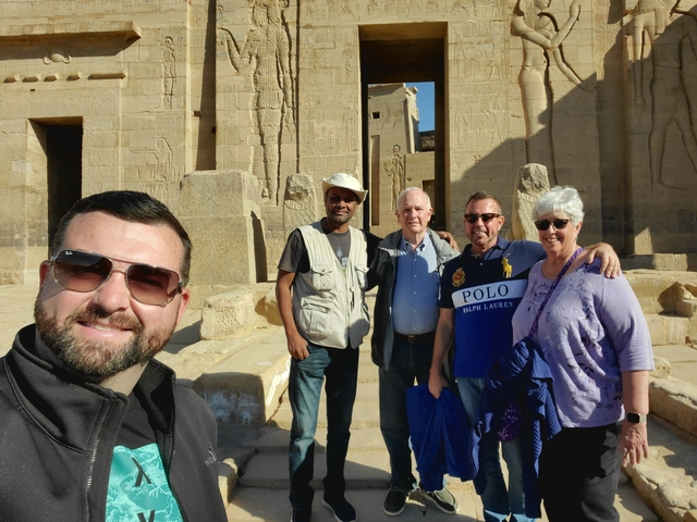 Group of tourists exploring ancient Egyptian ruins.