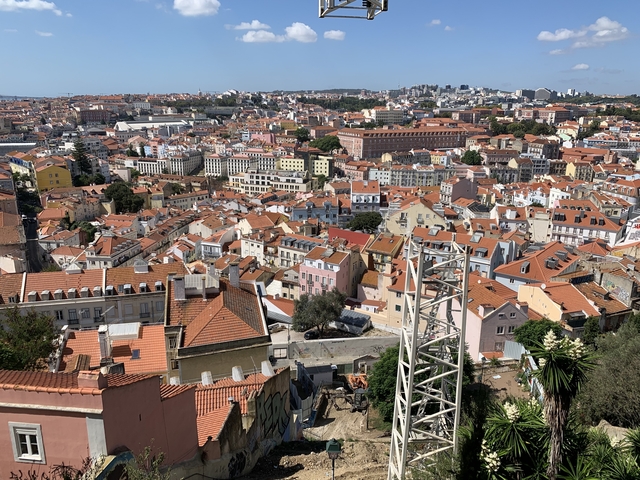 Aerial view of a densely packed city with orange rooftops.