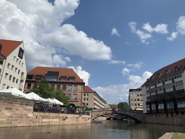 Riverside buildings with clear skies.