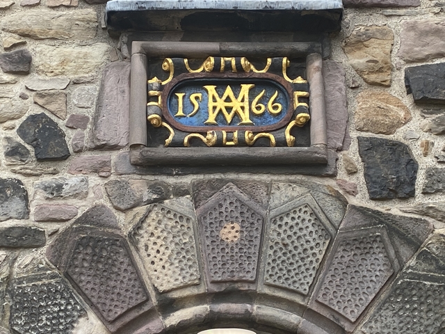       Decorative stonework with date inscription.
  