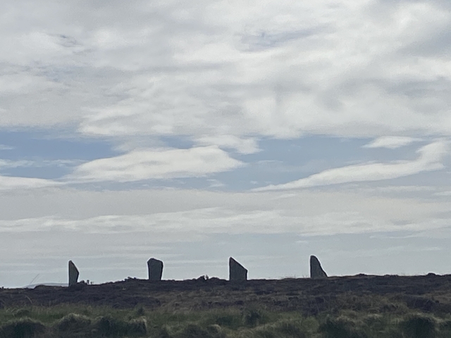       Distant view of ancient standing stones against a cloudy sky.
  