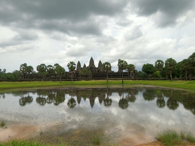       Angkor Wat temple complex with reflection in water.
  