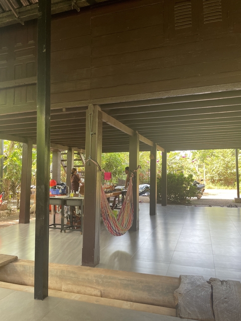       Covered outdoor seating area in village setting.
  