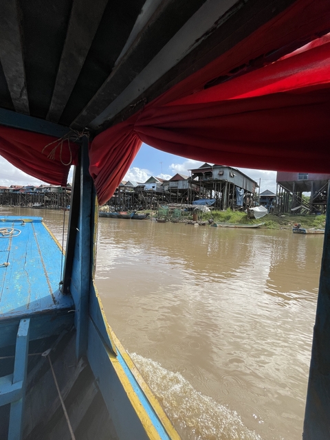       Floating village and river view from boat.
  