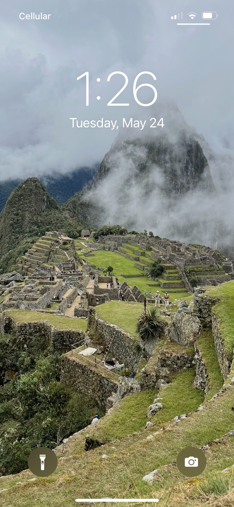 Scenic view of Machu Picchu surrounded by mist.