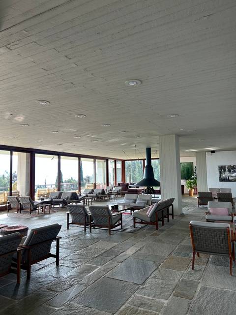 Interior of a modern building with tables and chairs.