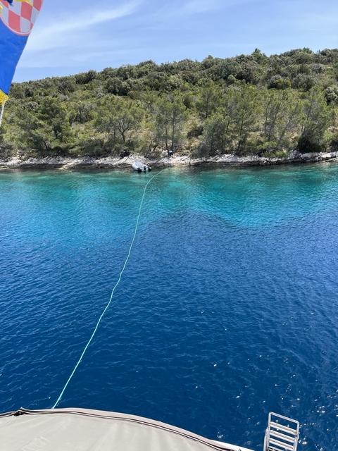 Clear blue water by the rocky shore.
