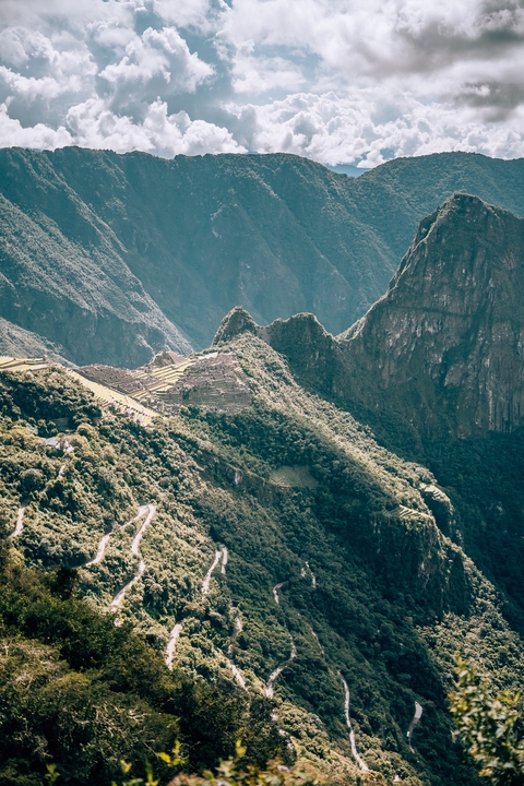 Aerial view of Machu Picchu and surrounding mountains.