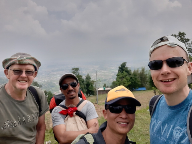       Four people posing with a scenic background.
  