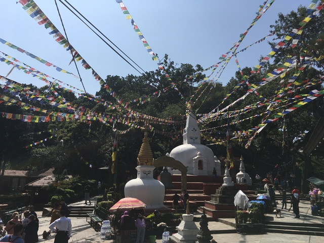       Stupas with prayer flags streaming over them.
  