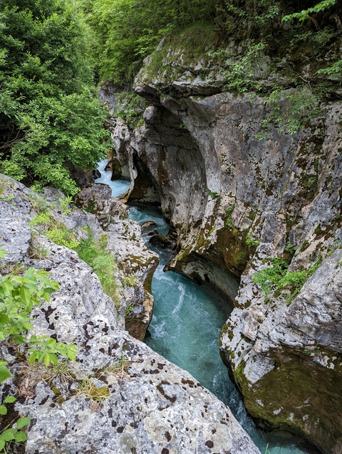       Stunning gorge with clear blue water flowing between rock formations
  
