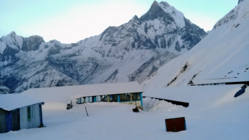       Snow-covered buildings with a mountain backdrop
  