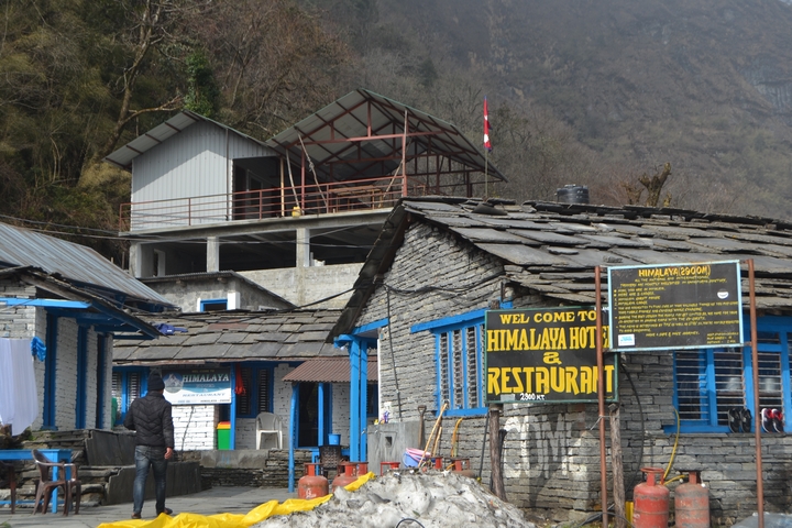       Exterior of a restaurant in a mountain village, with visible signage
  