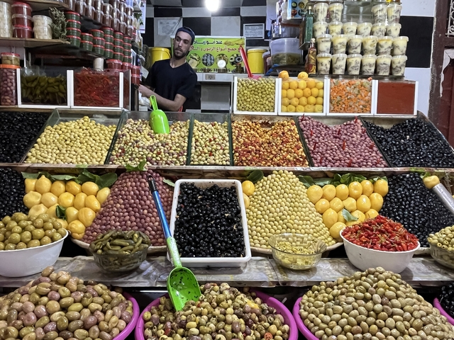       Market stall with a variety of olives and pickled items.
  