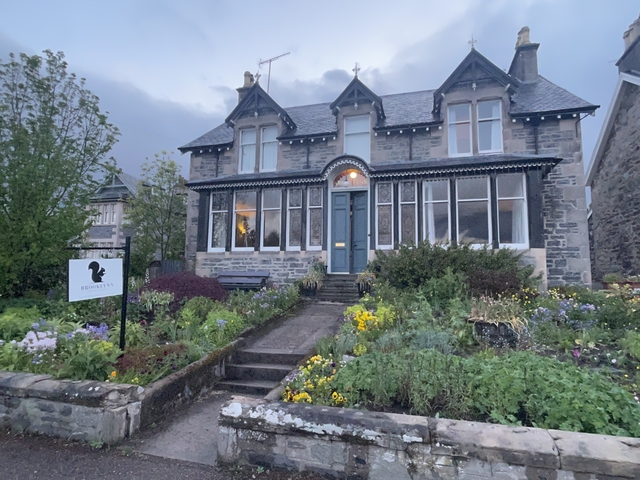 Charming stone house with a garden in front.
