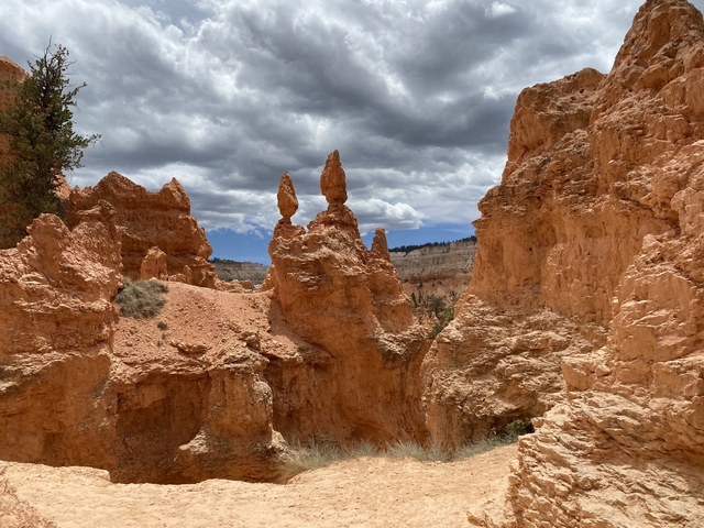       Orange rock formations under a partly cloudy sky.
  
