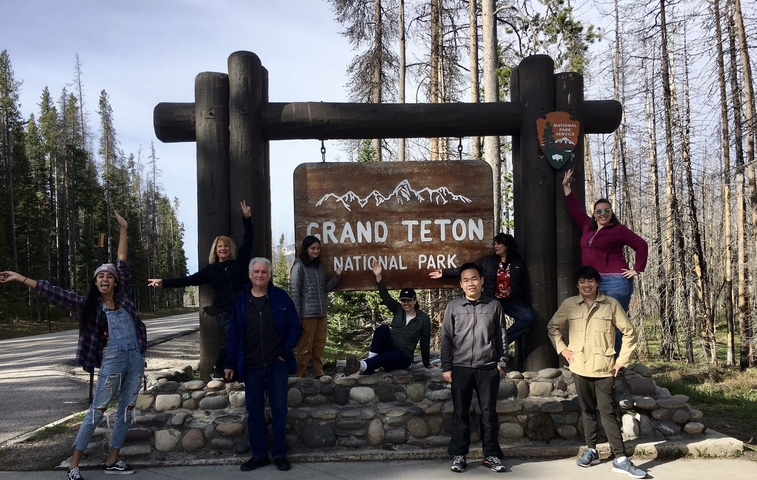 Group posing at the entrance to Grand Teton National Park.