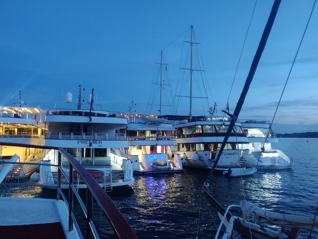 Moored yachts at a marina during twilight.