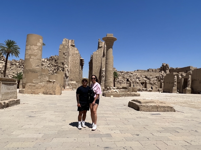 Two people posing in front of ancient temple ruins