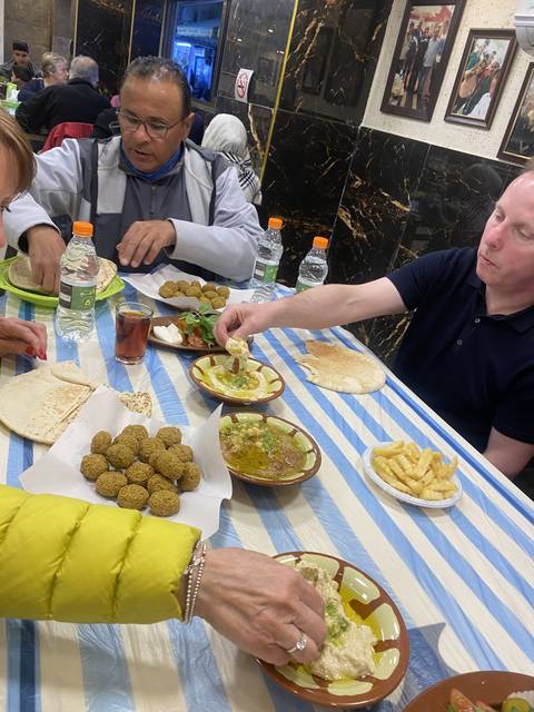People dining with traditional Middle Eastern food.