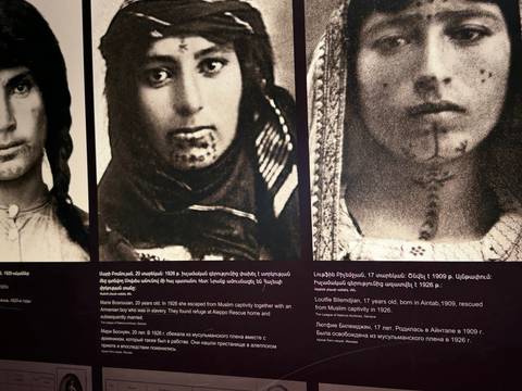       Historical photographs displayed on a wall.
  