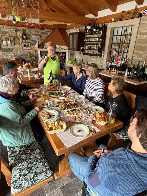 Group of people having a meal together at a table.
