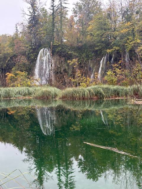       Reflection of a waterfall in a lake.
  