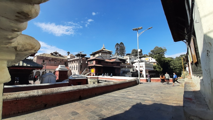       Pedestrian area with temples and tourists.
  