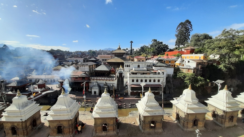       Temples in a cityscape with people.
  