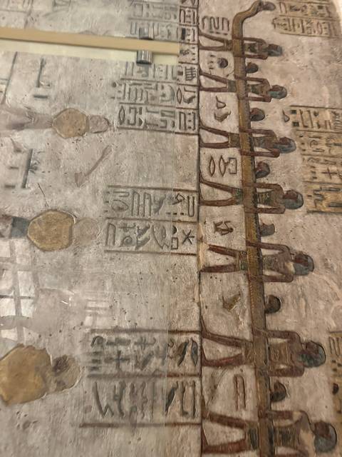       Egyptian hieroglyphs on a stone wall.
  