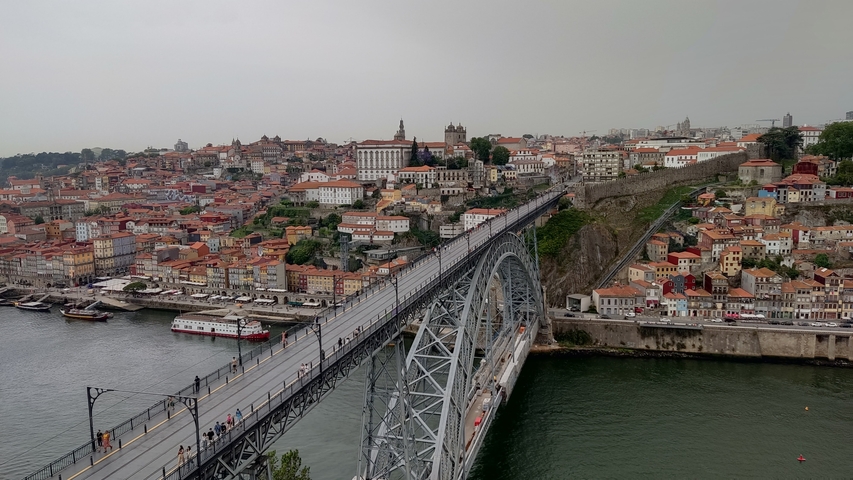       A cityscape of Porto, Portugal with the Dom Luís I Bridge over the river.
  