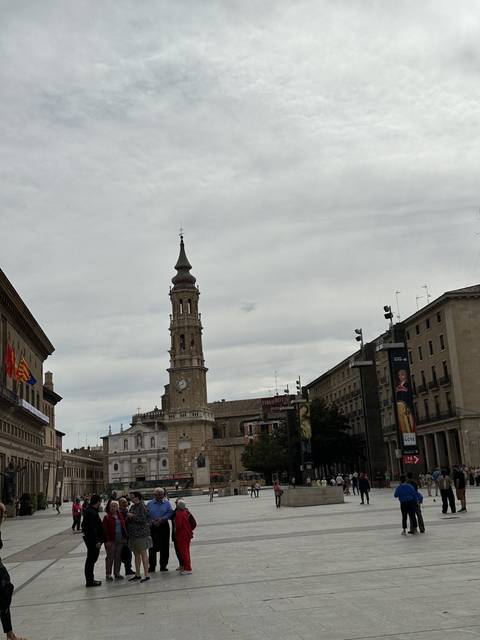 People walking in a historic public square.