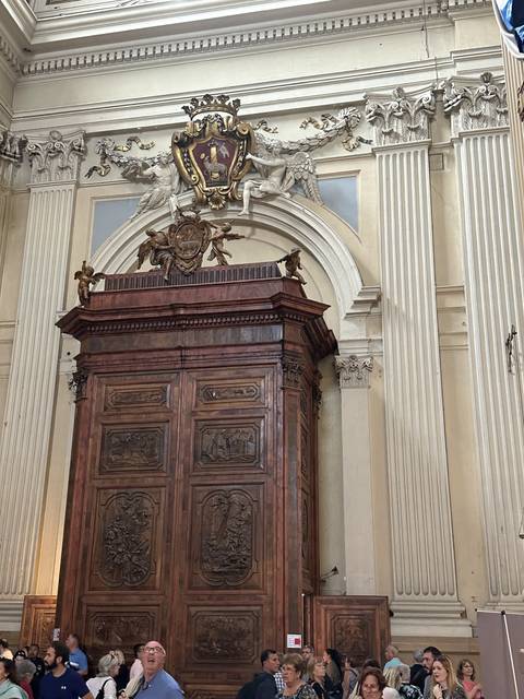      Interior of a historic building with wooden elements and decorations.
  