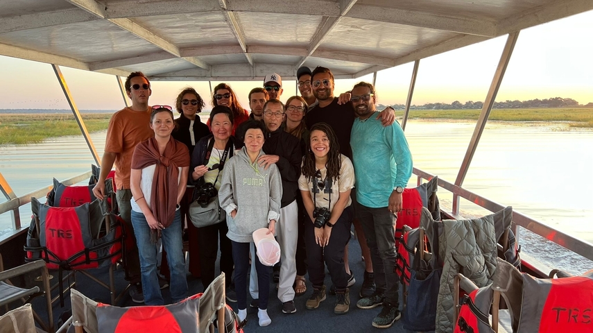       Group of people posing on a riverboat.
  