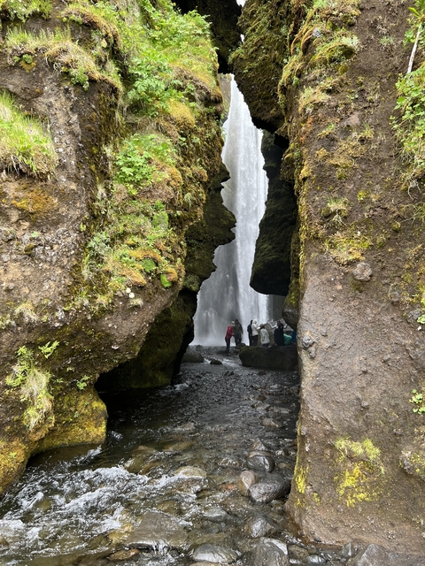 Waterfall viewed between mossy rocks