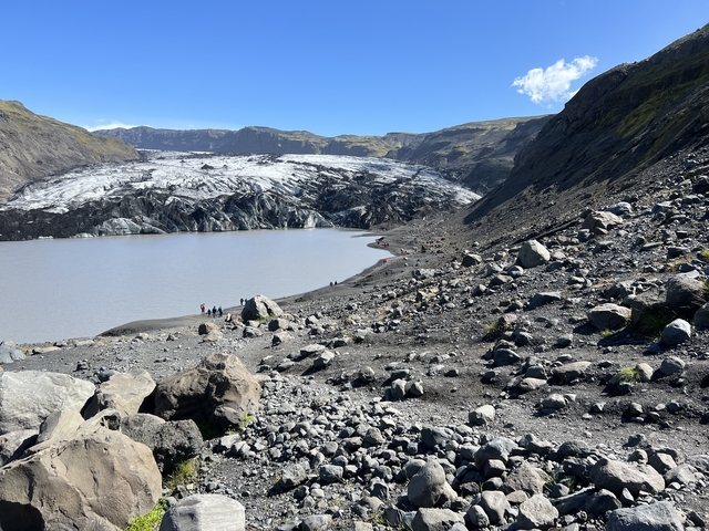       Glacier and lake surrounded by rocky terrain
  