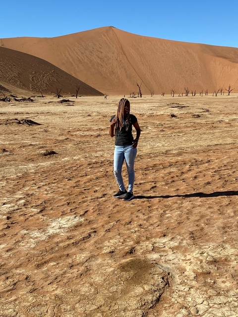 Woman standing on a dry landscape.