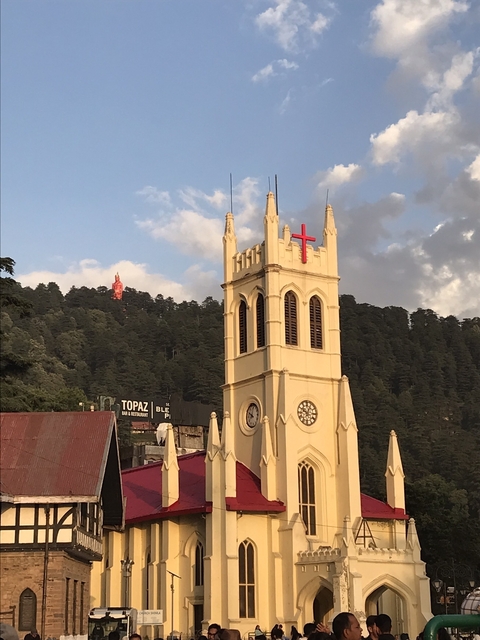 Church with a red cross on a hill