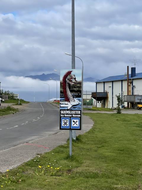       Rotated signpost with images and text.
  