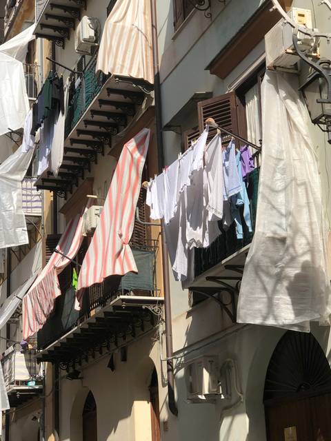       Clothes hanging to dry outside a building.
  