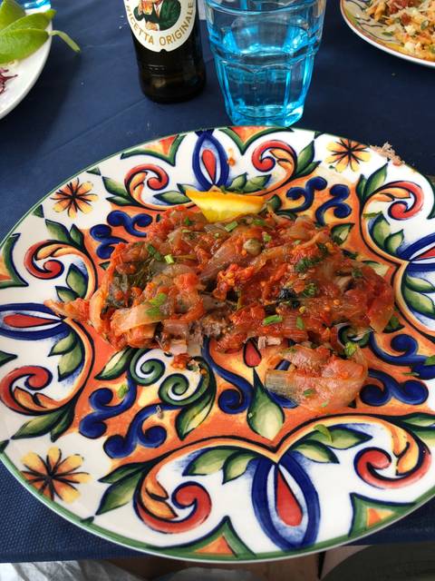       Colorful Sicilian dish on a decorative plate.
  