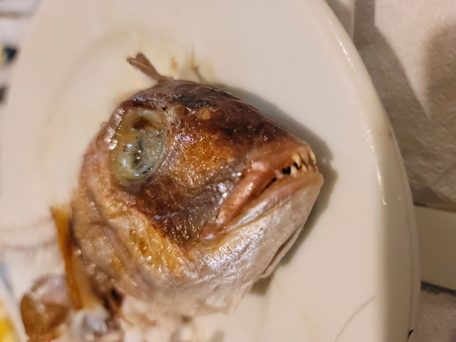       Close-up of a cooked fish on a dish.
  