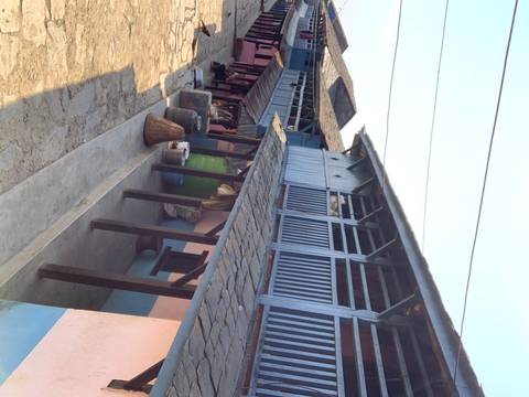      Traditional wooden buildings along a stone pathway.
  