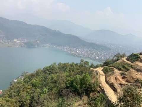       Aerial view of a lake with a town on its shore.
  